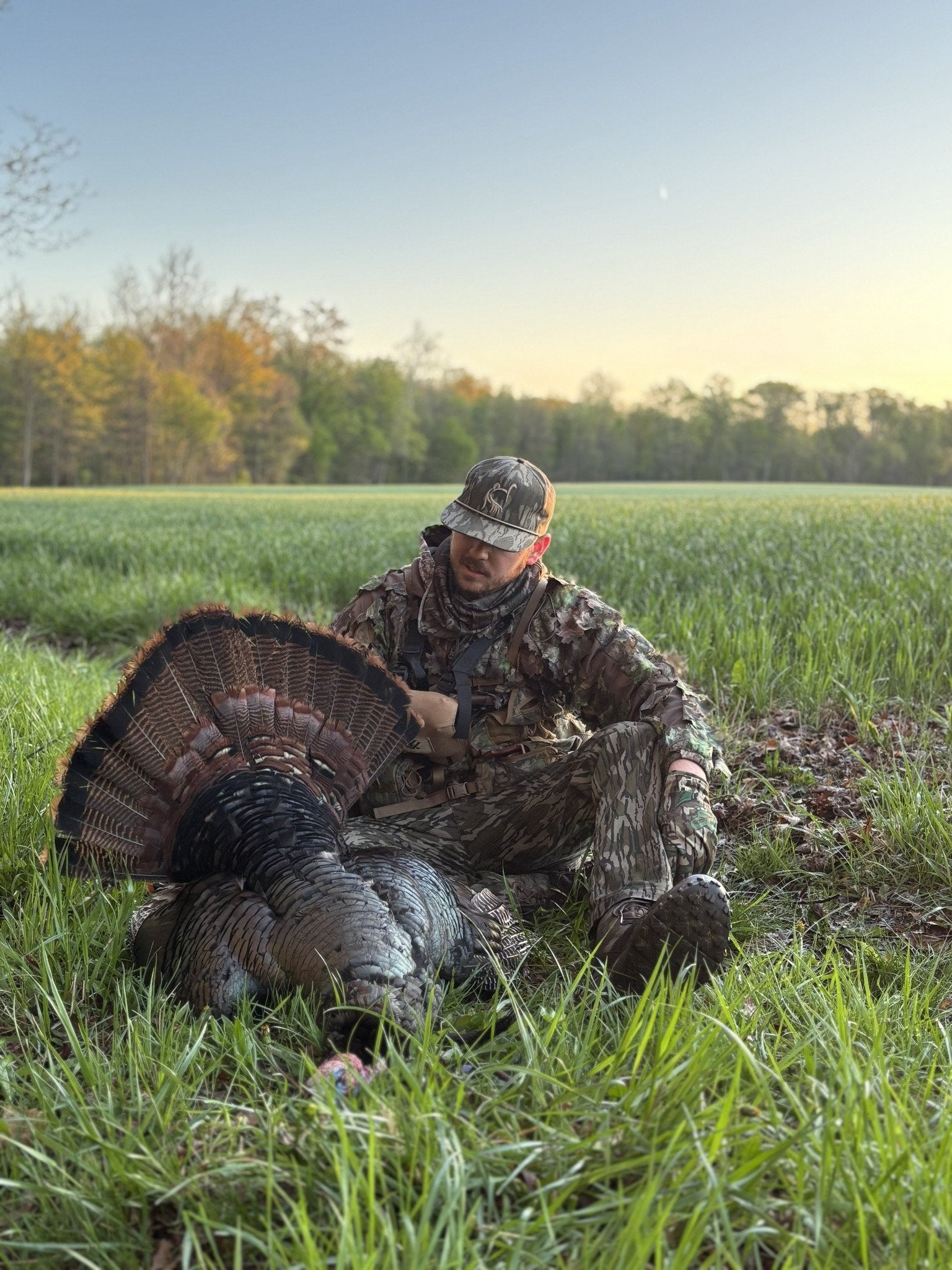 Zak beside a harvested turkey in the field